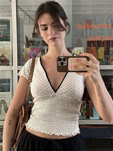 Women's white V-neck printed short sleeve top.